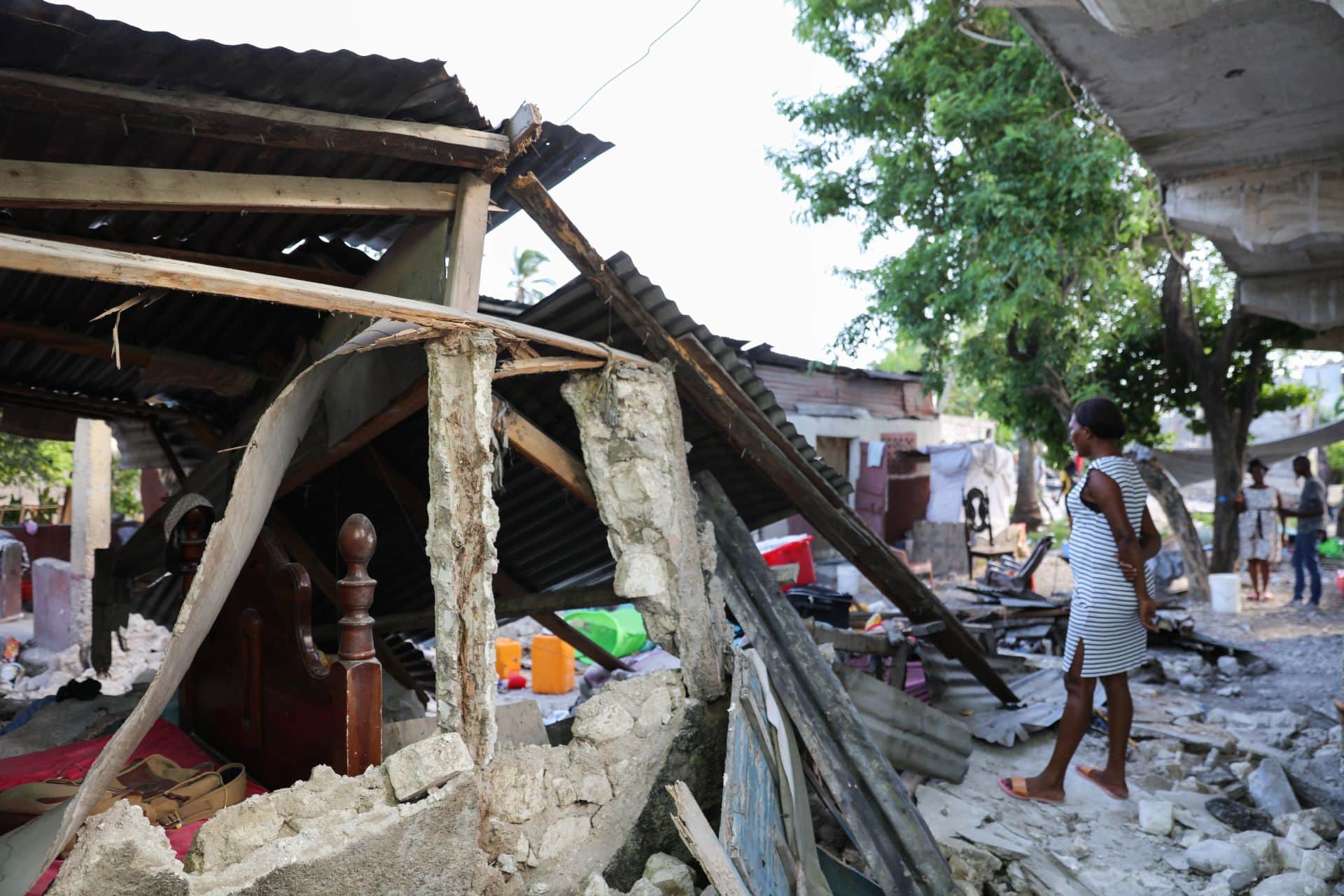 Woman stands in the earthquake wreckage