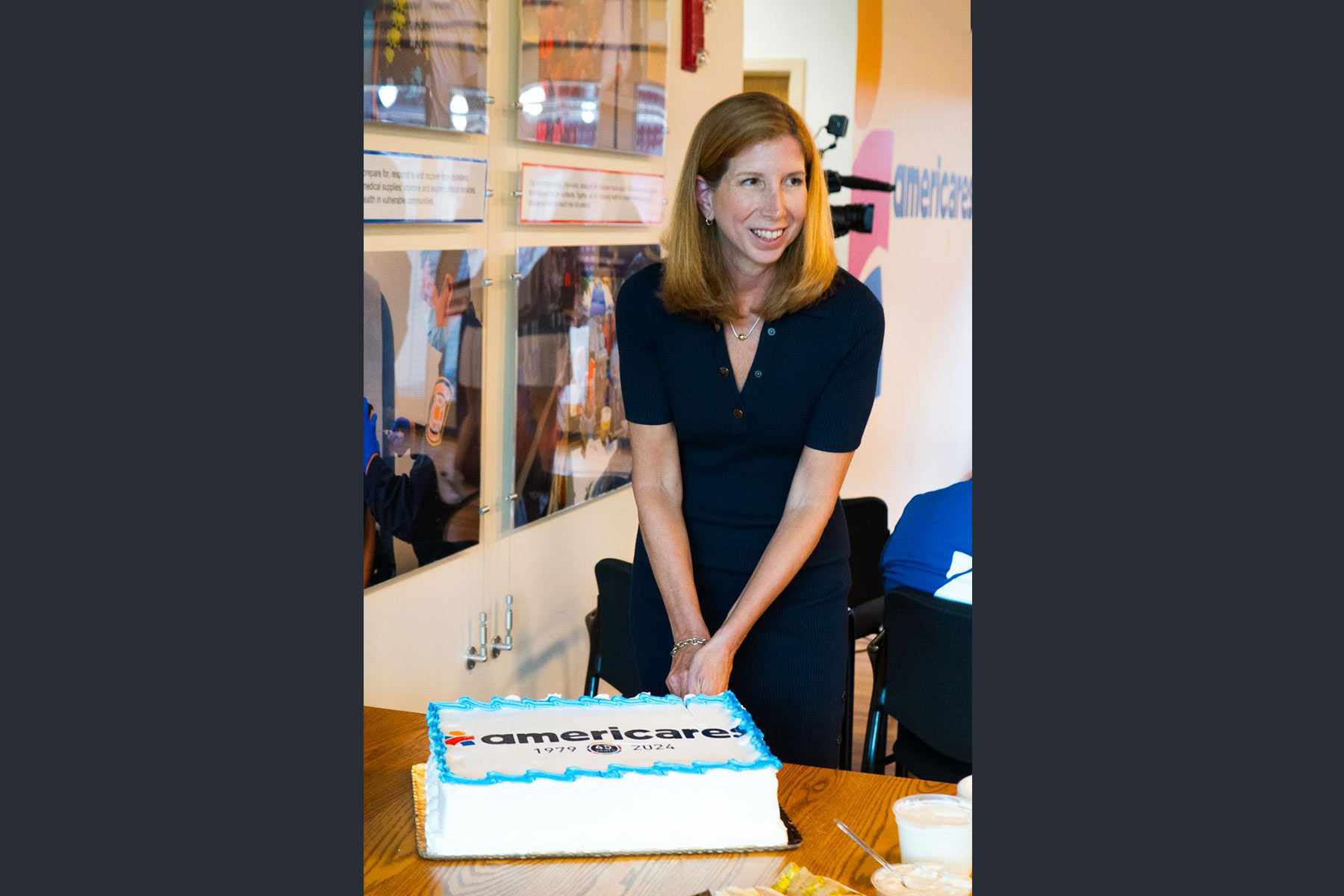 Americares President and CEO Christine Squires cuts the cake during the 45th anniversary celebration on Aug. 6, 2024. Credit to Stephen Emerick for Americares.